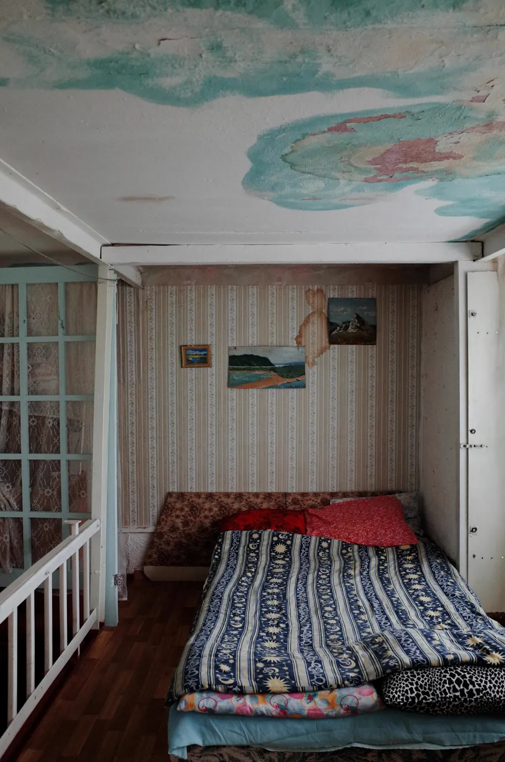 Water-stained ceiling above a bedroom caused by a roof leak