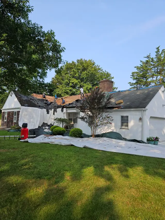 Tom Jannace Roofing crew installing premium asphalt shingles