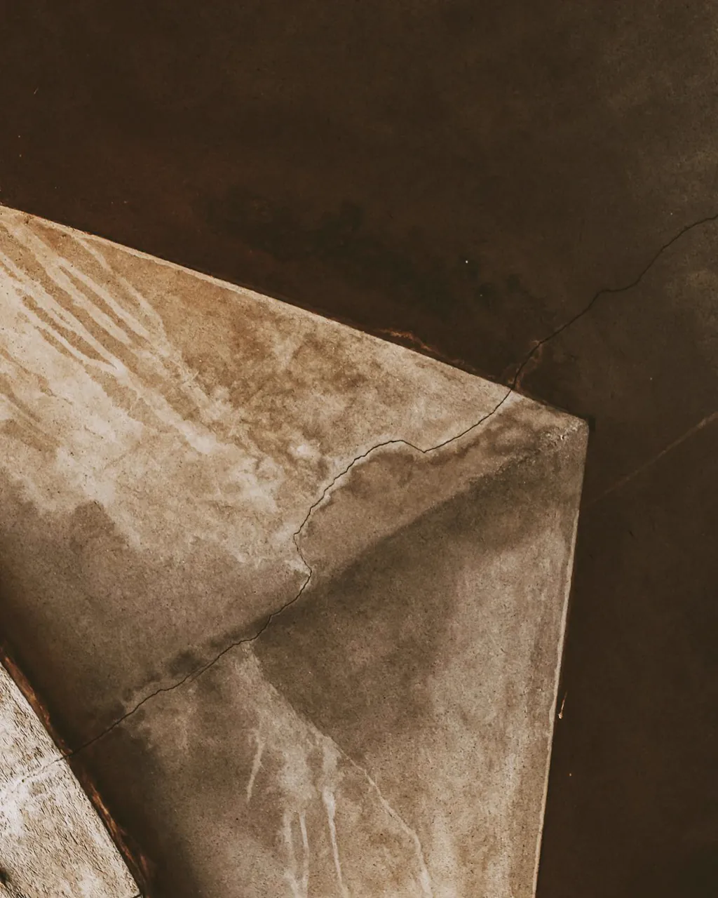 Water stain spreading across a ceiling from an untreated roof leak