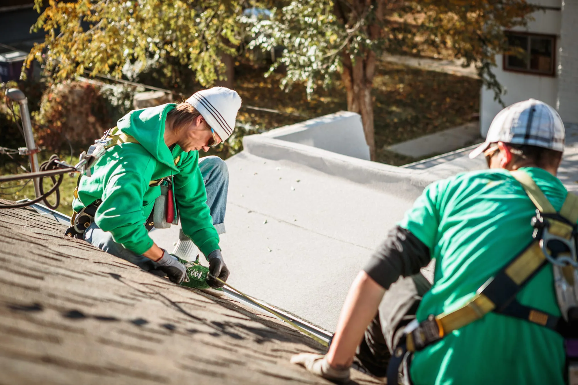 Roofing crew working on an asphalt roof
